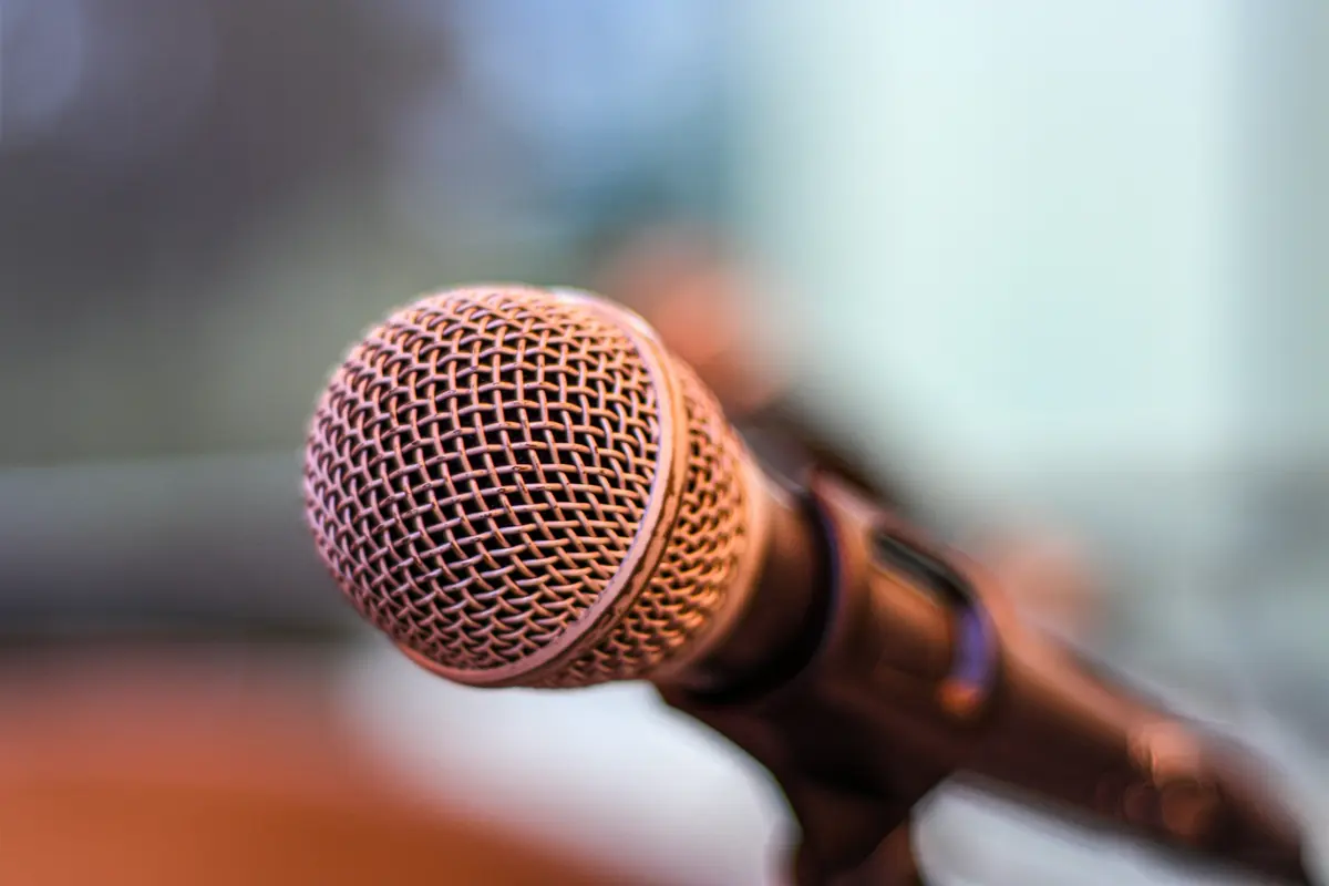 A close-up of a microphone in warm light