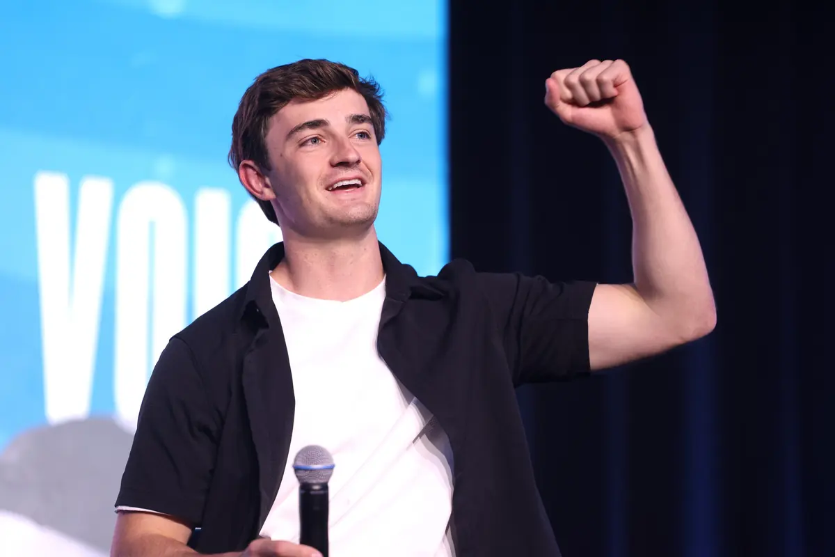 Nick Shirley raising a fist on stage at a 2026 event